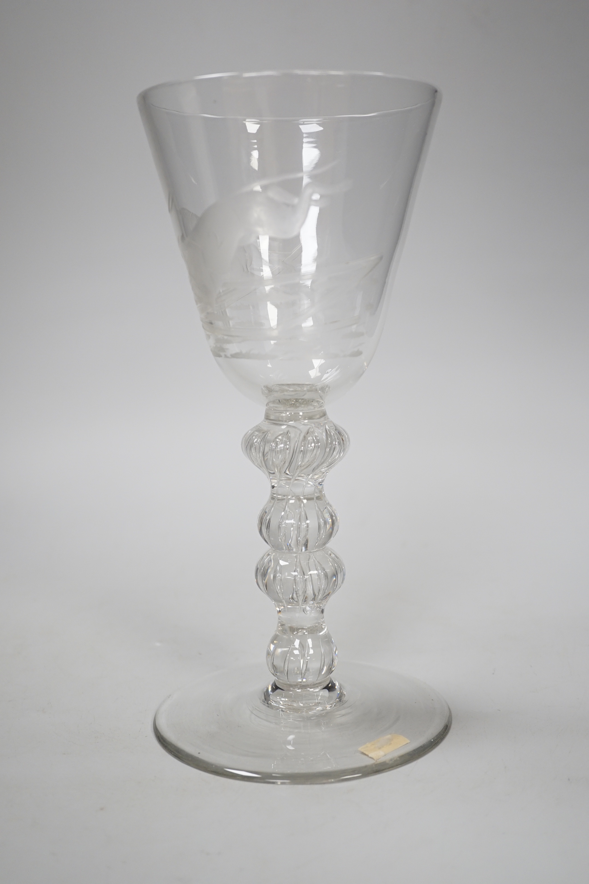 An English lead crystal mammoth trophy goblet, 19th century / early 20th century, engraved with two racing greyhounds, coats numbered 1 and 2, leaping a hurdle, four knopped multiple teared stem and a wide foot with brok